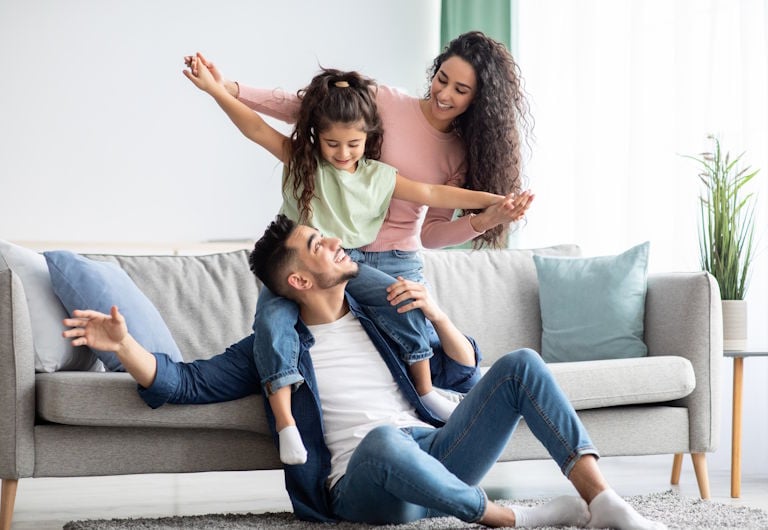 Man looks down at his laptop in a home workspace with the word work superimposed over him.